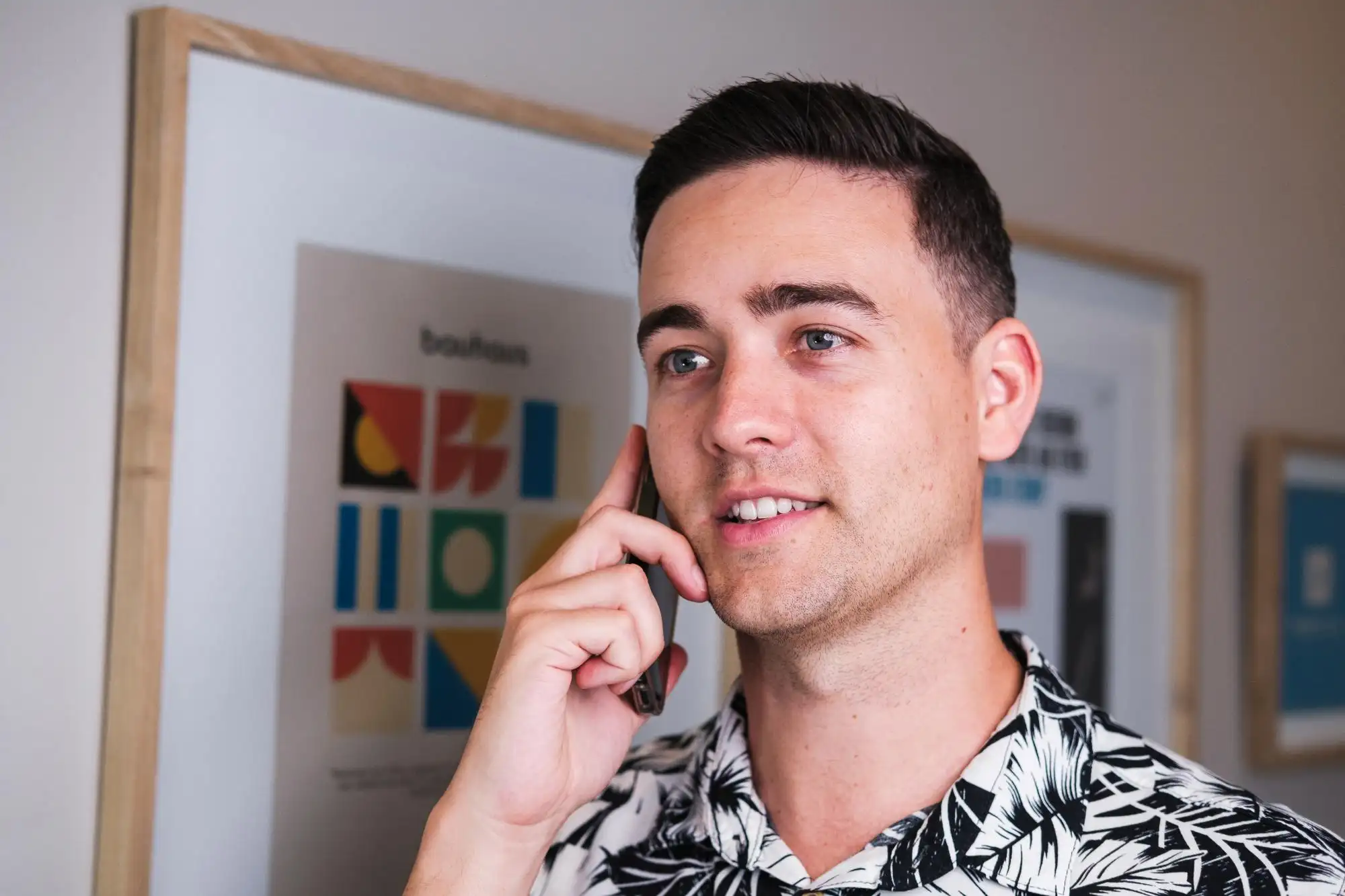 Ryan Cumming on a call with a client at his desk