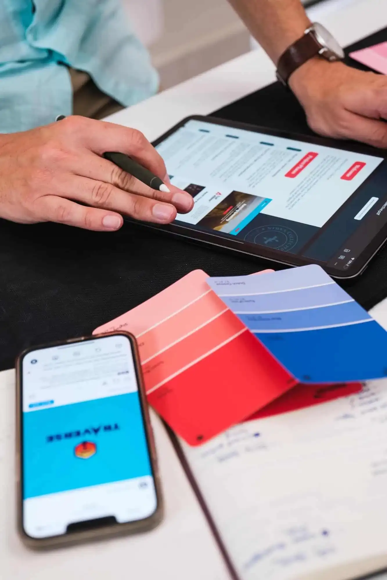 A website design open on a tablet next to colour swatches